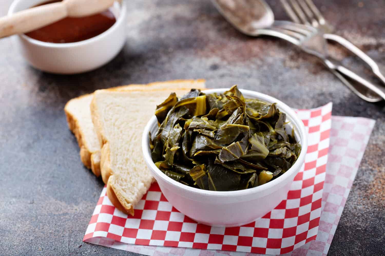 Cooked collard greens in a foam bowl, southern barbeque side