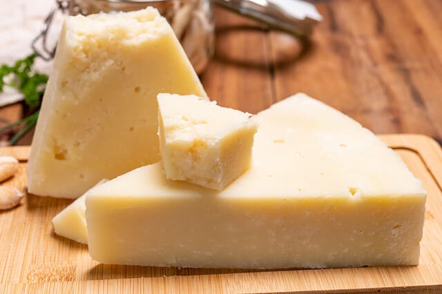 Pieces of matured pecorino romano italian cheese made from sheep milk in Lazio, Sardinia or Tuscany close up