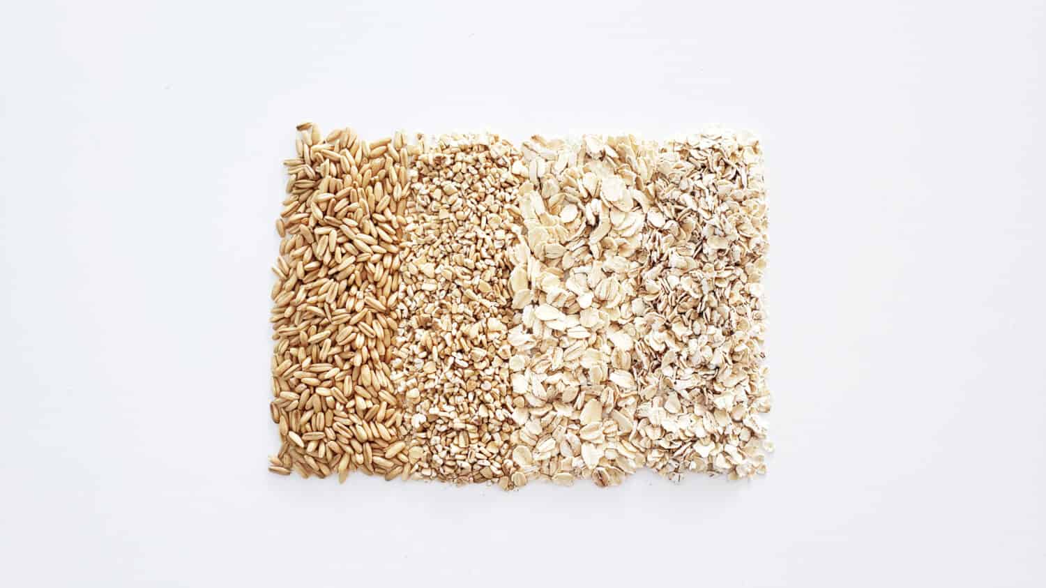 four different types of oats, whole oat, steel cut oat, rolled oat, quick oat on white background