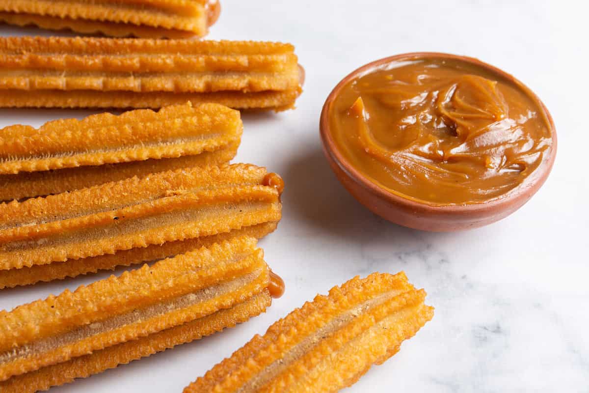fried churros filled with dulce de leche