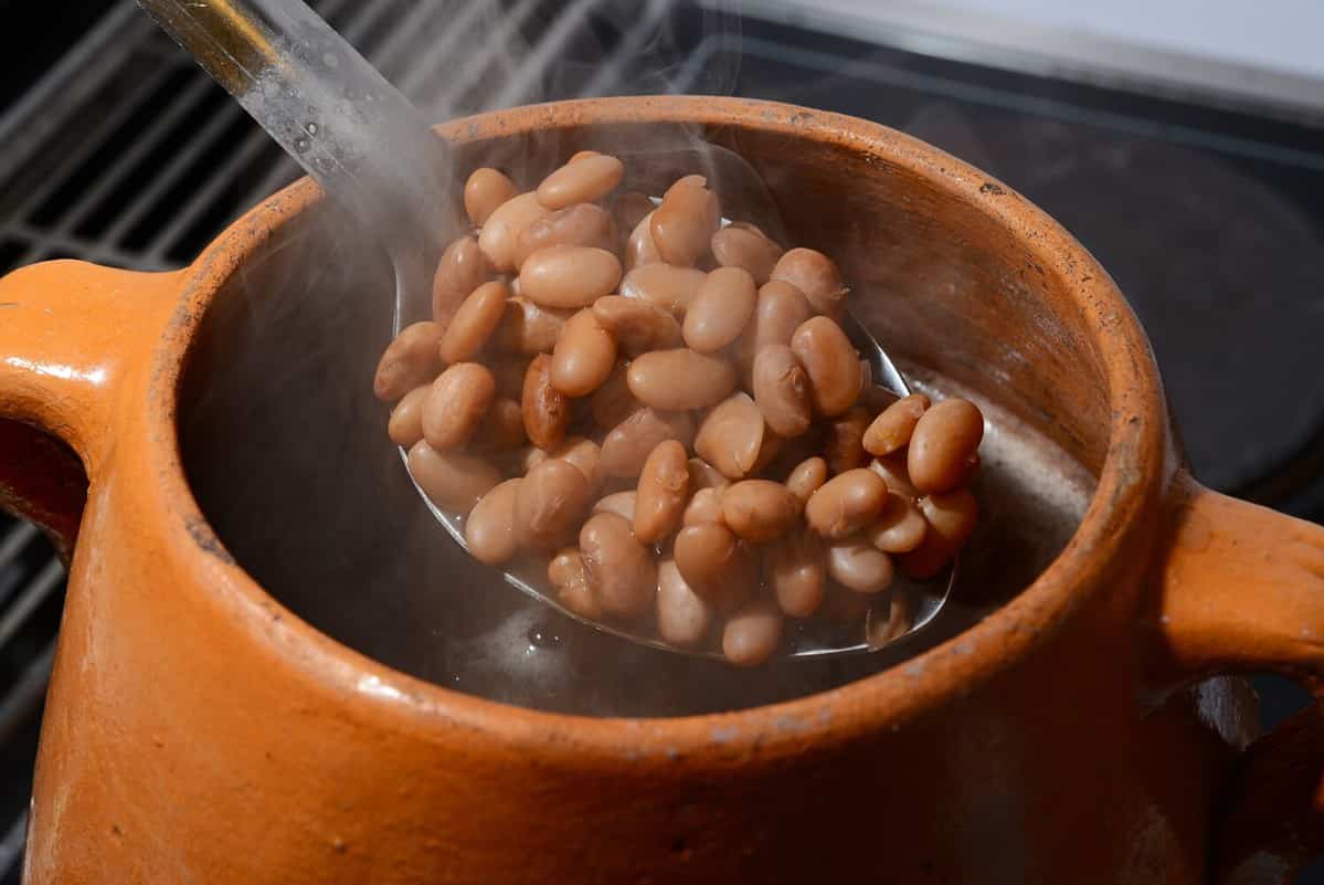 Closeup of clay cooking pot with pinto beans
