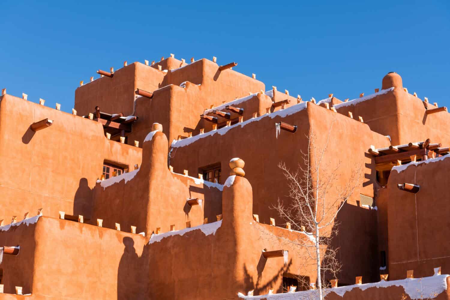 Winter scene of snow-covered adobe pueblo style building in Santa Fe, New Mexico
