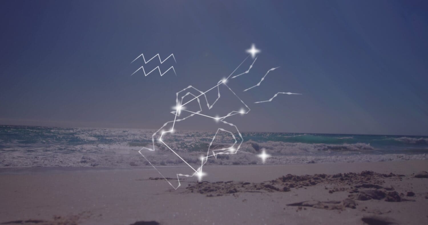 Image of aquarius star sign with glowing stars over sea and beach. Astrology, horoscope and zodiac sign concept digitally generated image.