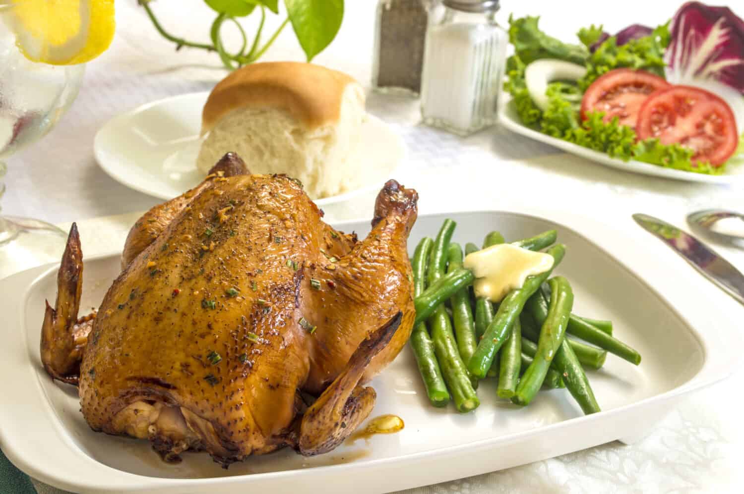 Cornish game hen with fresh vegetables and roll ready to enjoy for dinner or lunch "Cornish hen meal"