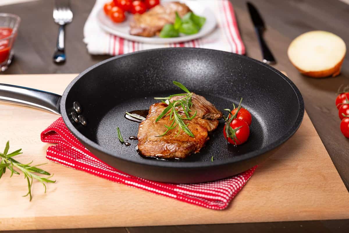 Pork neck steak in a teflon pan