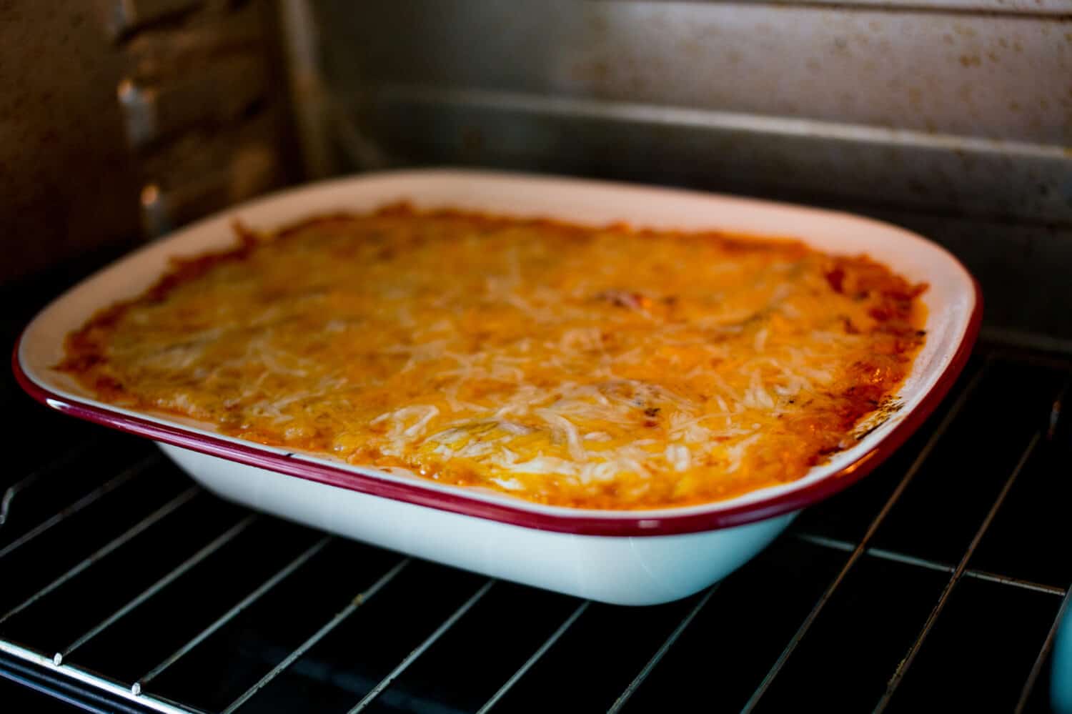 Homemade stewed rice bake with cheese, and tomato sauce.