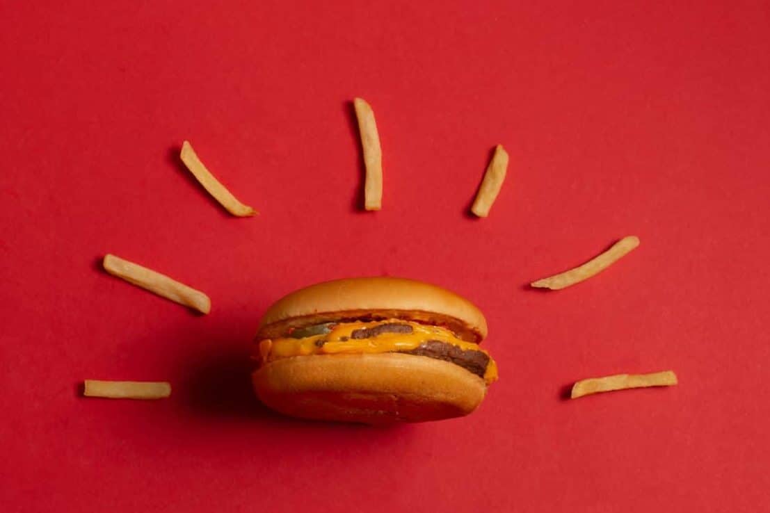 McDonald's menu: French fries and burger on red background. Minimal concept