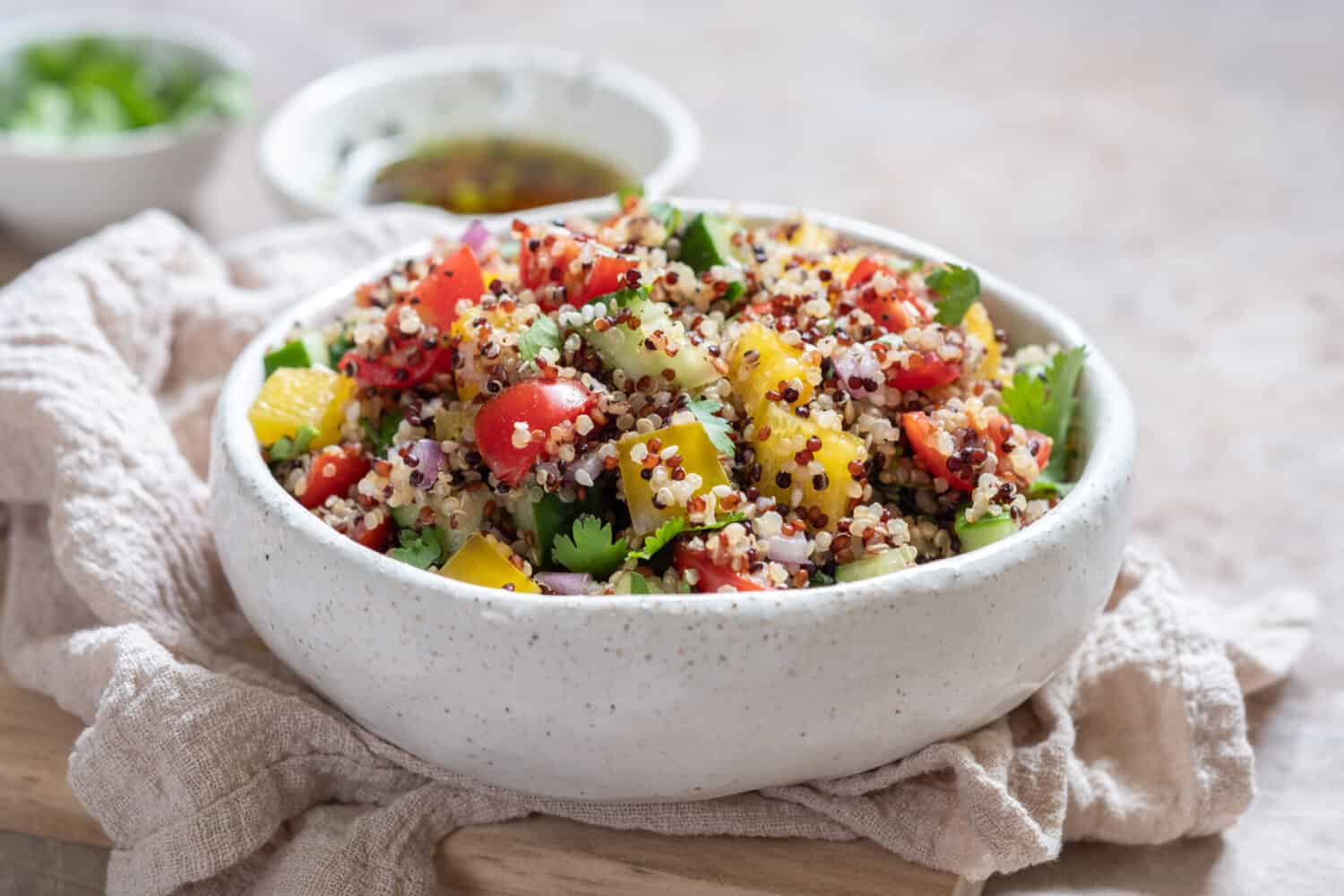 Fresh quinoa tabbouleh salad with tomatoes, peppers and cucumbers