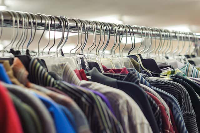 Goodwill is an American nonprofit organization and a second-hand store that creates jobs. Items donated to the thrift store are resold to the public. Retail coat hangers merchandised on racks in store