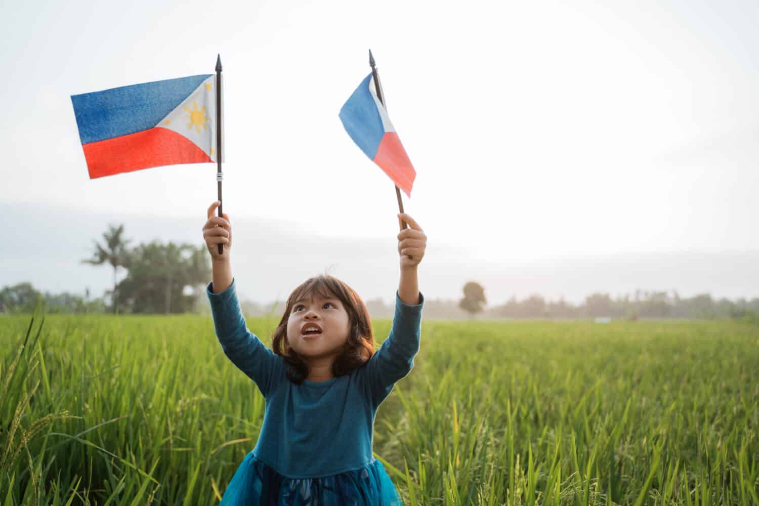 happy phillipine kid with national flag outdoor