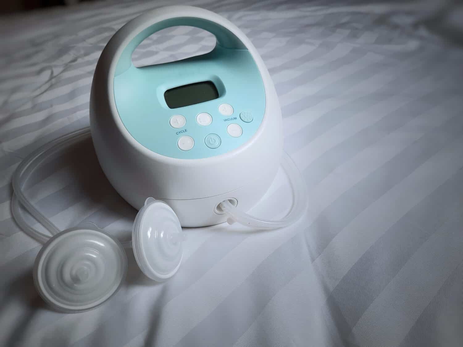 A electric breast pump on white blackground.