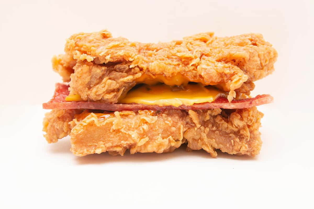 Double Down burger, a sandwich made of two pieces of fried chicken fillet instead of the typical bread, containing bacon, cheese, and sauce.