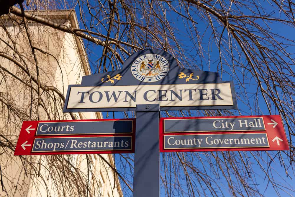Close up, isolated image of a sign post located in the town center of Rockville, Maryland showing directions of shops, courts and government offices. Rockville is the county seat of Montgomery County.