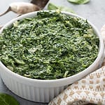 Creamed spinach with garlic in a white bowl