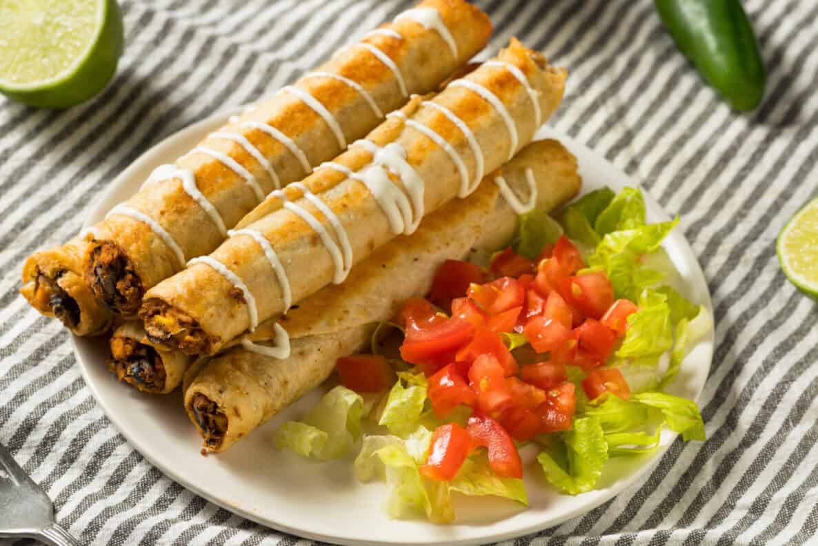 Homemade Mexican Chicken Flautas with Crema and Lettuce and Tomato