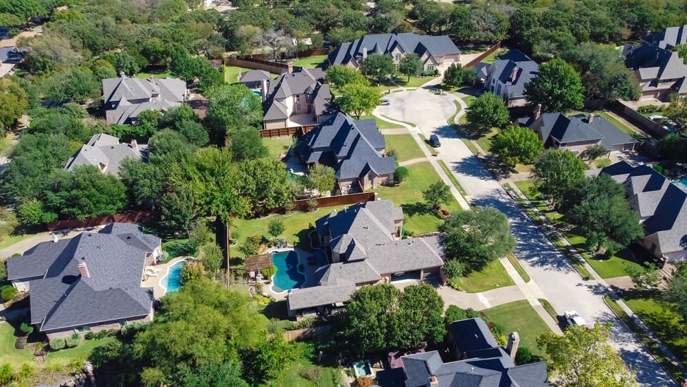 Aerial view luxury mansion style single family homes with swimming pools near a cul-de-sac in Grapevine, Texas, America