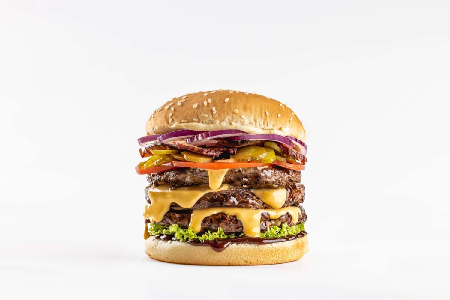 Huge burger with three levels on the white background