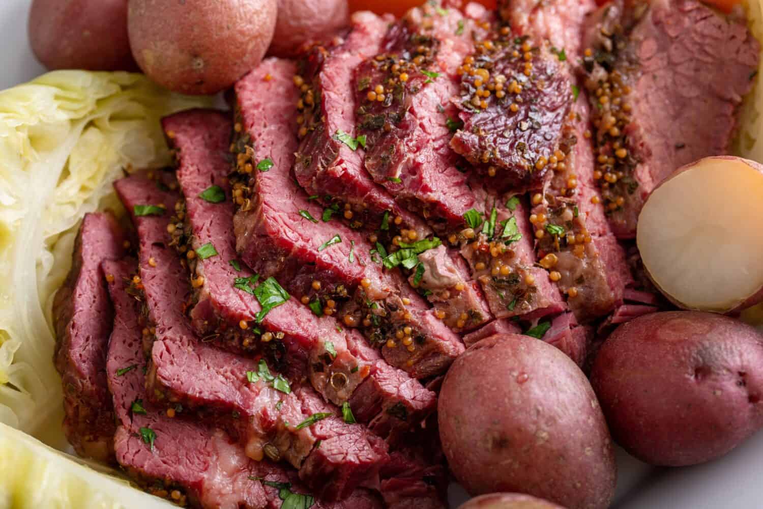 Corned beef with cabbage and potatoes on a serving platter, irish recipe idea for St Patricks day