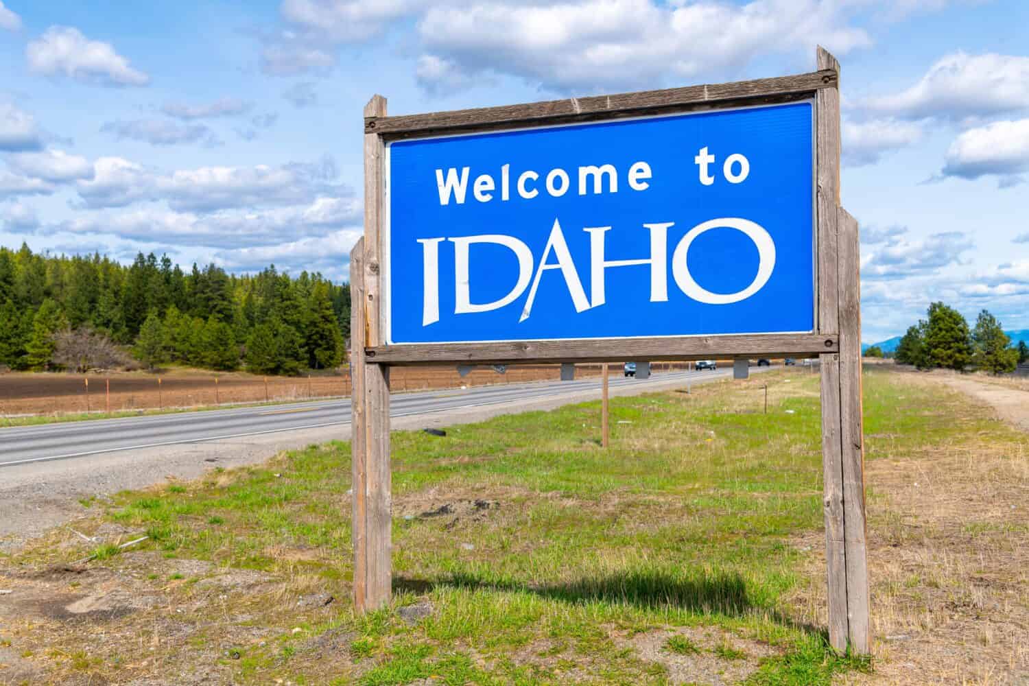 A roadside welcome to Idaho sign coming from Spokane Washington and entering North Idaho at Post Falls, Idaho, USA	