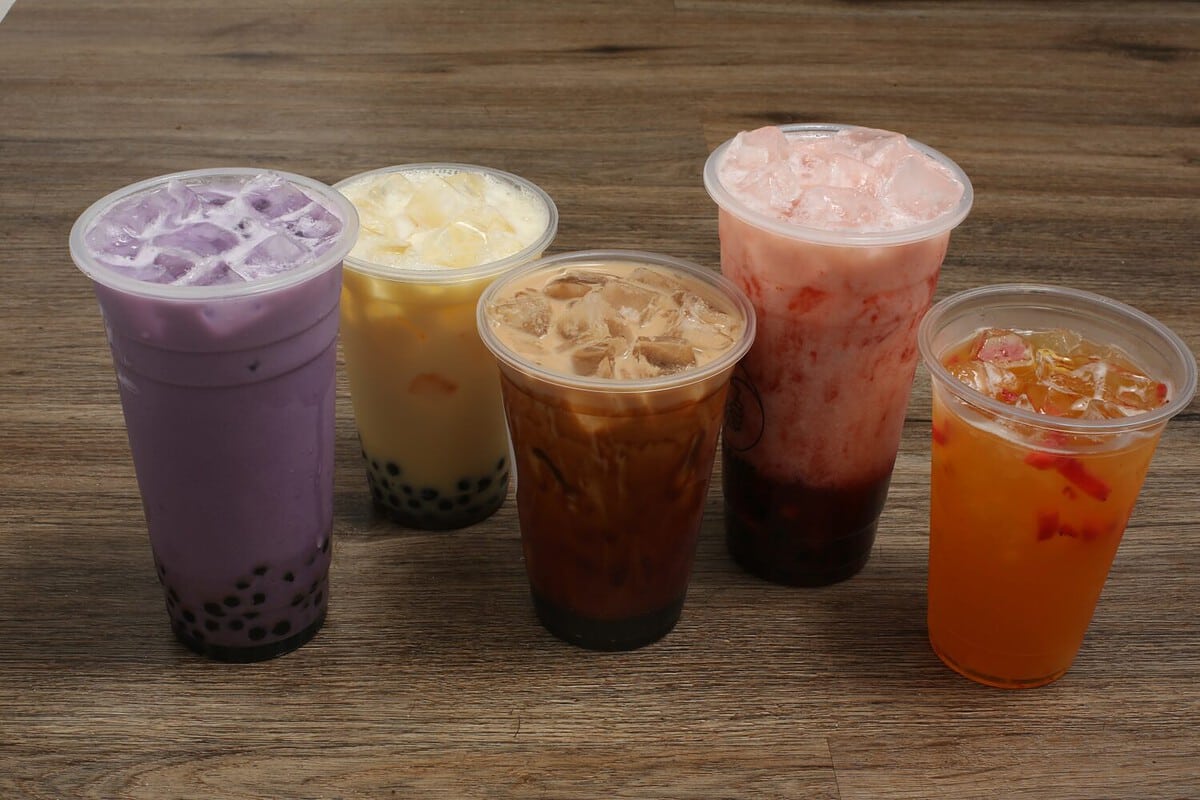 Boba and fruit teas on brown table top