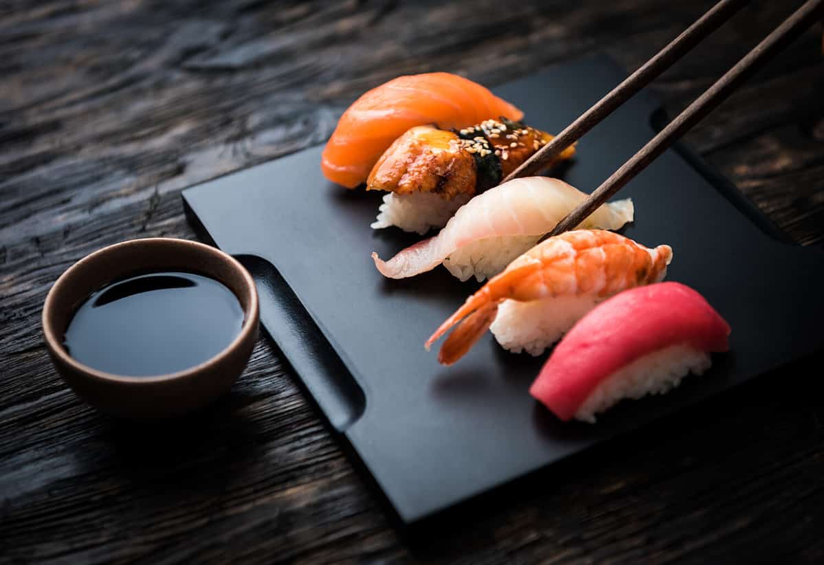 close up of sashimi sushi set with chopsticks and soy