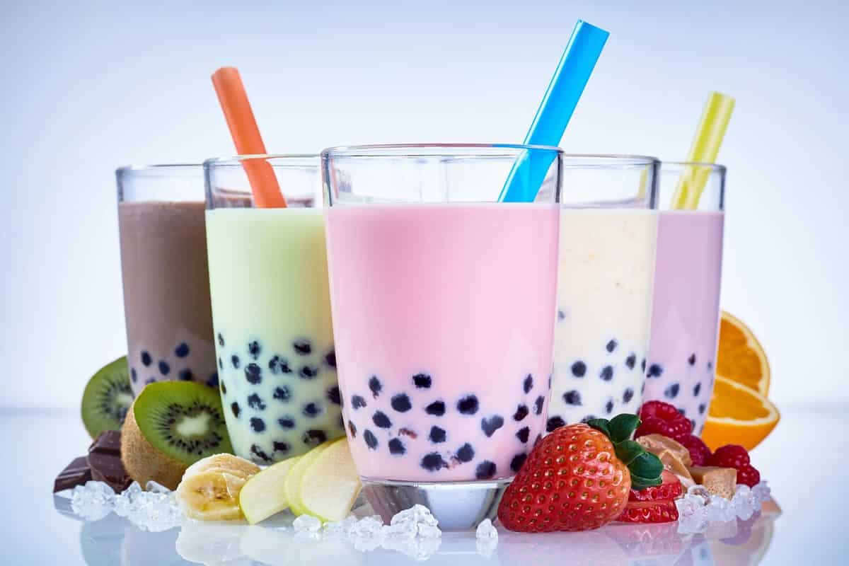 Refreshing iced milky bubble tea with tapioca pearls made with fresh fruit ingredients including raspberry, strawberry, kiwi, orange, apple and banana