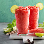 Watermelon slushie with lime, summer refreshing drink in tall glasses