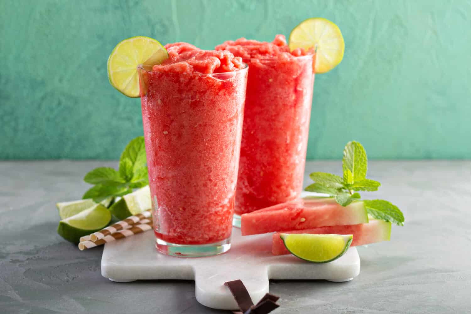 Watermelon slushie with lime, summer refreshing drink in tall glasses