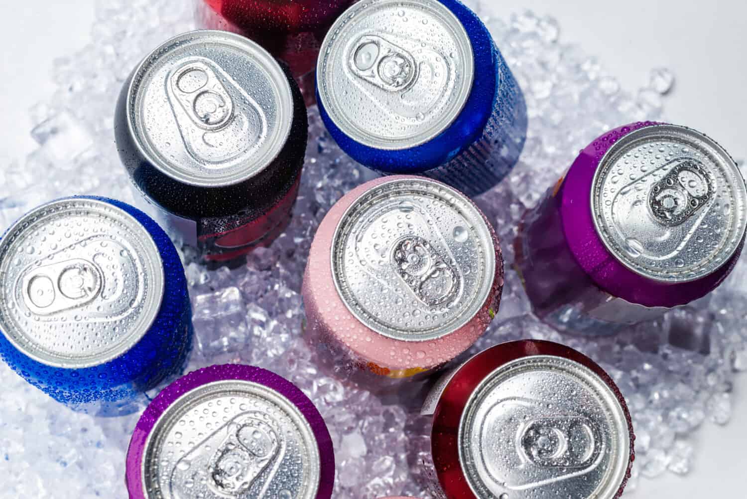 Group of aluminium cans in ice, cold drink. Top view.