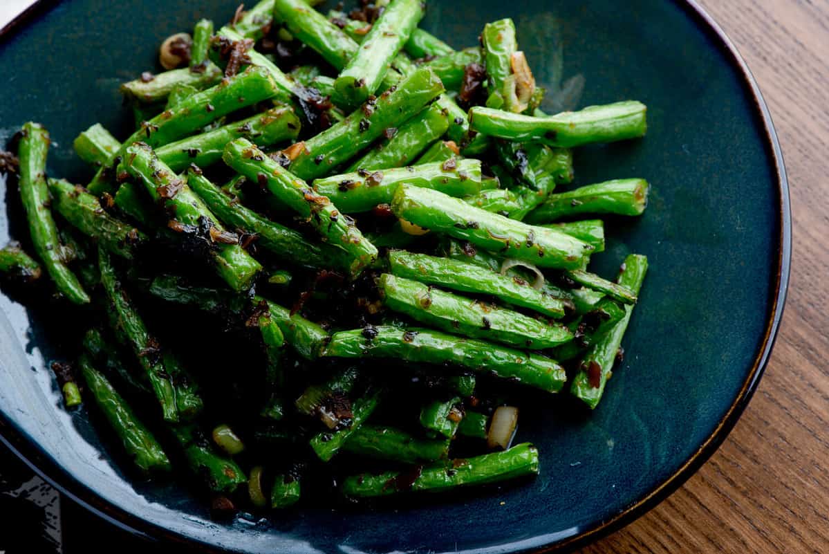 Green beans or haricots. Sautéed organic vegetable in olive oil, herbs, spices and salt and pepper. Classic American steakhouse, restaurant or bistro side dish.