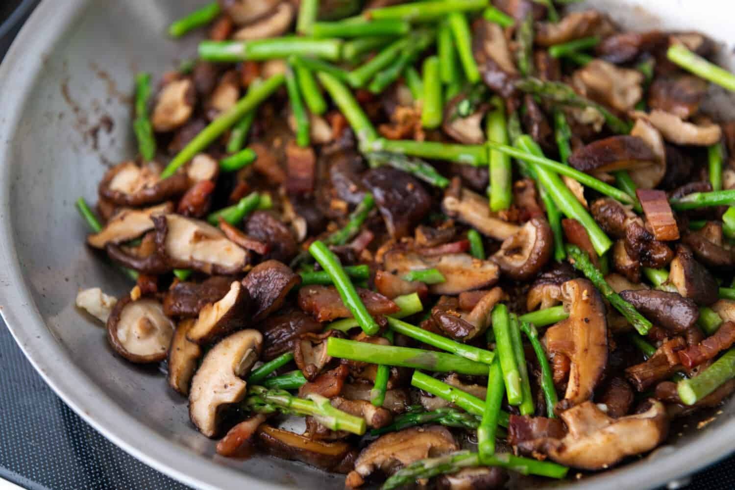 Shiitake Mushroom and Young Asparagus Sautéed in Skillet for Vegan Dinner