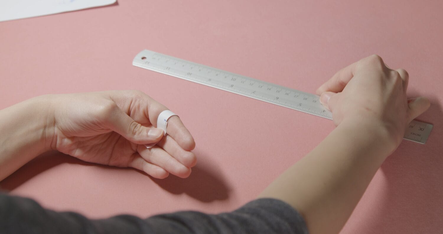 girl doing measurement for ring size