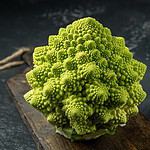 Romanesco broccoli head on a dark stone surface, cabbage, close up, fibonacci sequence, for those who love mathematics