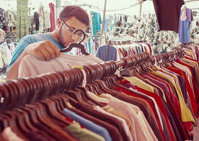 Young man buying in second hand store