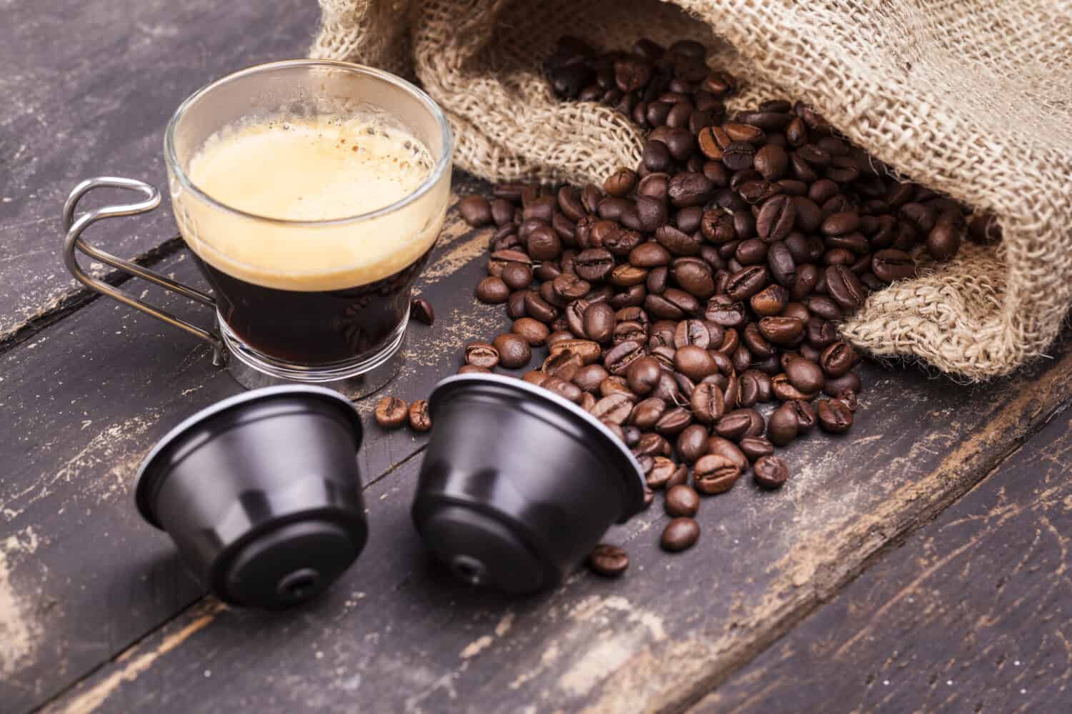 Coffee cup and capsules on a rustic wooden table