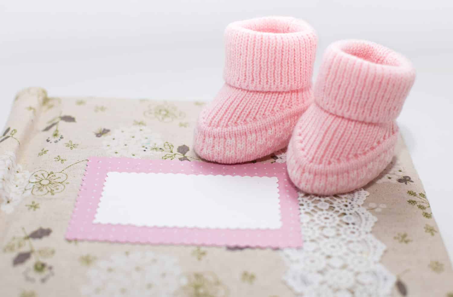 Pink newborn shoes on the album