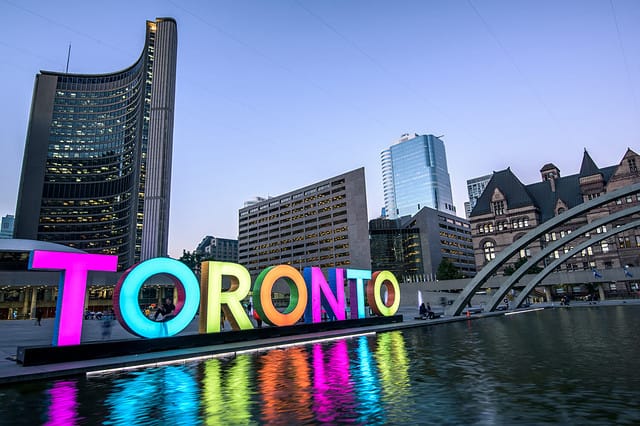 Toronto city hall and Toronto Sign in downtown at twilight, in Toronto, Ontario, Canada