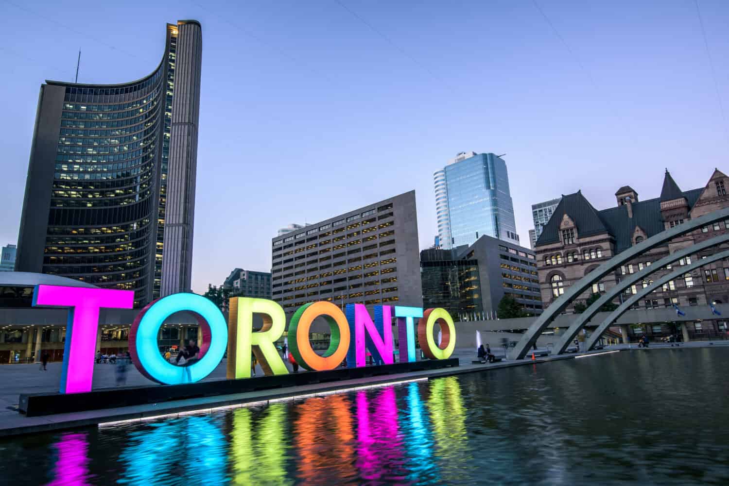 Toronto city hall and Toronto Sign in downtown at twilight, in Toronto, Ontario, Canada