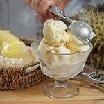 Still life photography of Durian ice cream on the table, shooting in studio. Popular fruit for dessert in Asian served with durian and sticky rice, Tropical dessert fruit concept for advertising.