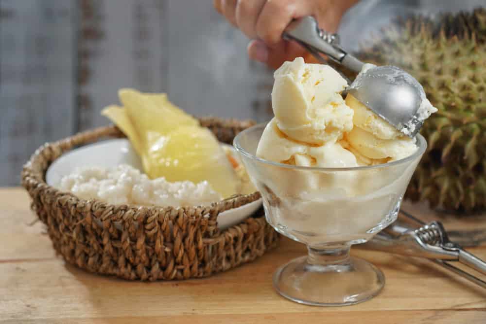 Still life photography of Durian ice cream on the table, shooting in studio. Popular fruit for dessert in Asian served with durian and sticky rice, Tropical dessert fruit concept for advertising.
