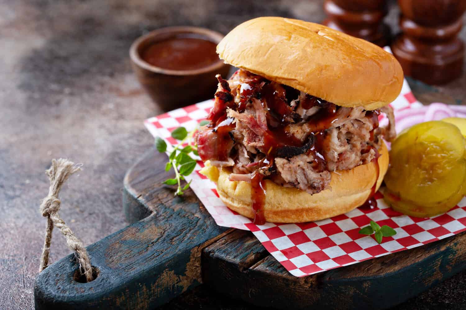 BBQ smoked pulled pork sandwich with pickles and barbeque sauce