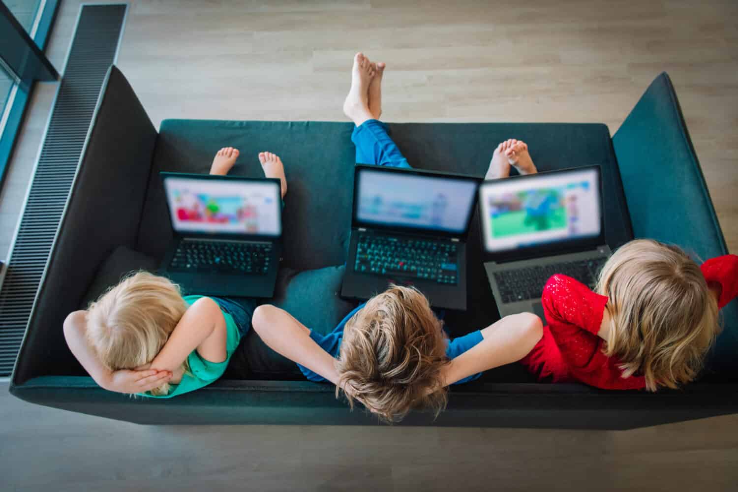 kids looking at laptop while staying home, family on qurantine