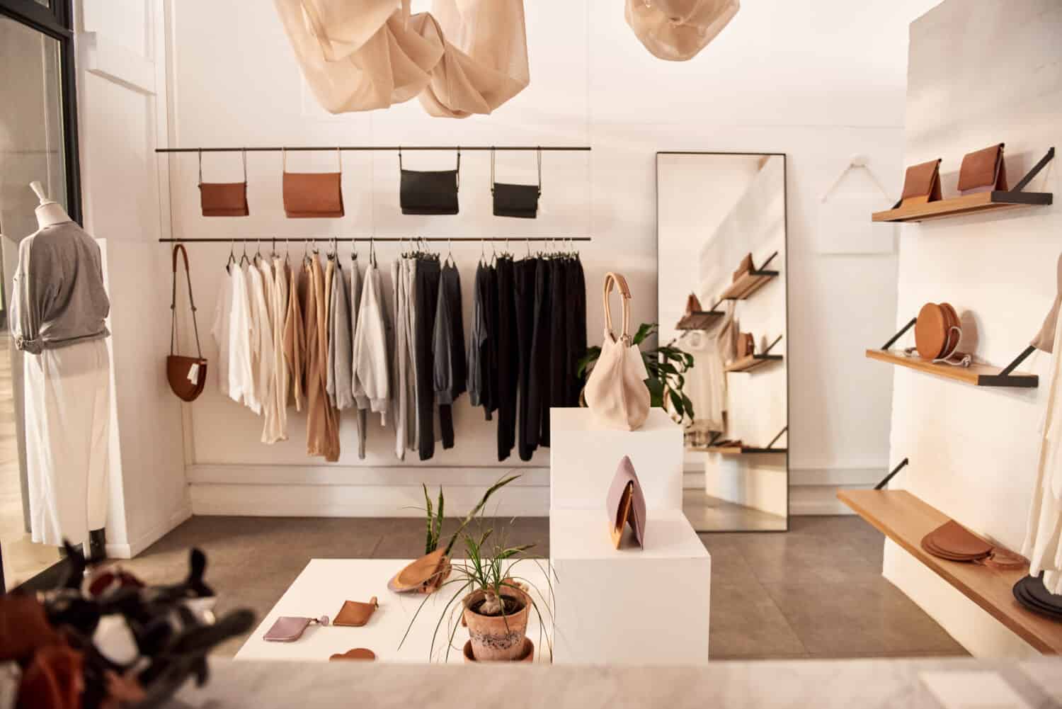 Interior of a fashionable clothing boutique full of an assortment of bags and accessories on display