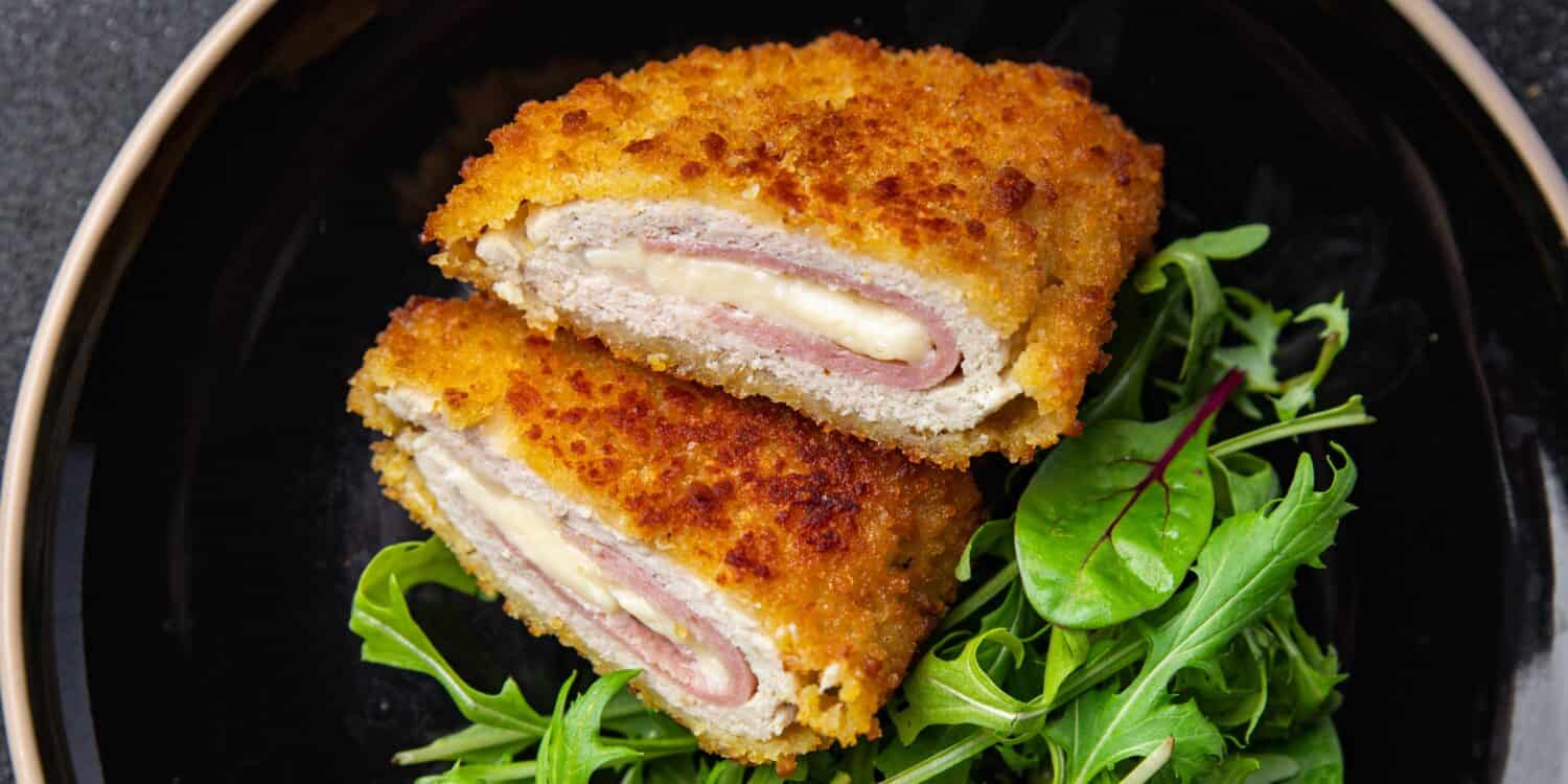 cordon bleu cutlet chicken meat, cheese, bacon meal snack on the table copy space food background rustic top view