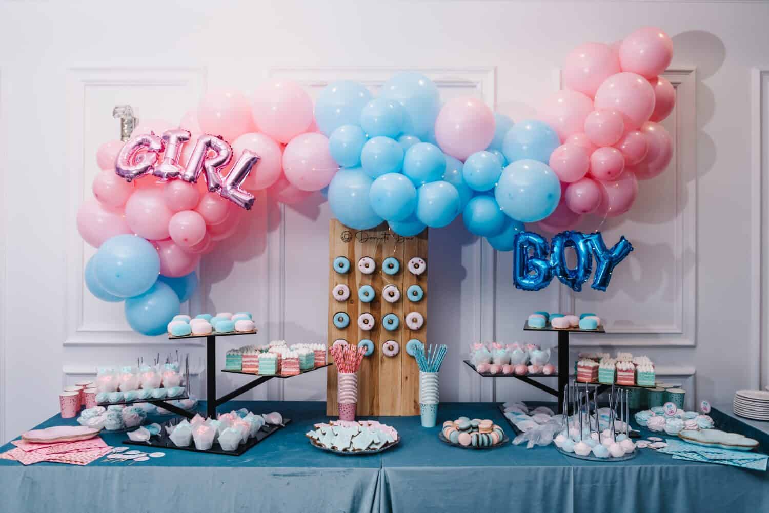 Baby Shower party decor. Delicious reception. Celebration concept. Trendy candy bar. Table with sweets, candies, dessert. Photo zone, arch with pink and blue balloons for gender party. Girl or boy.
