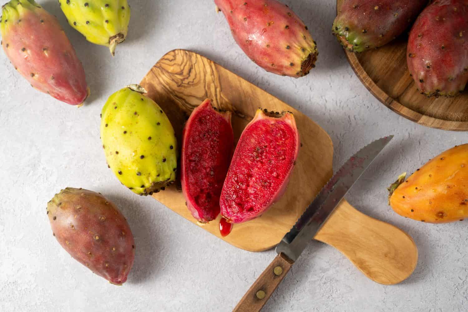 Prickly pears, exotic cactus fruits cut in halves, top view.
