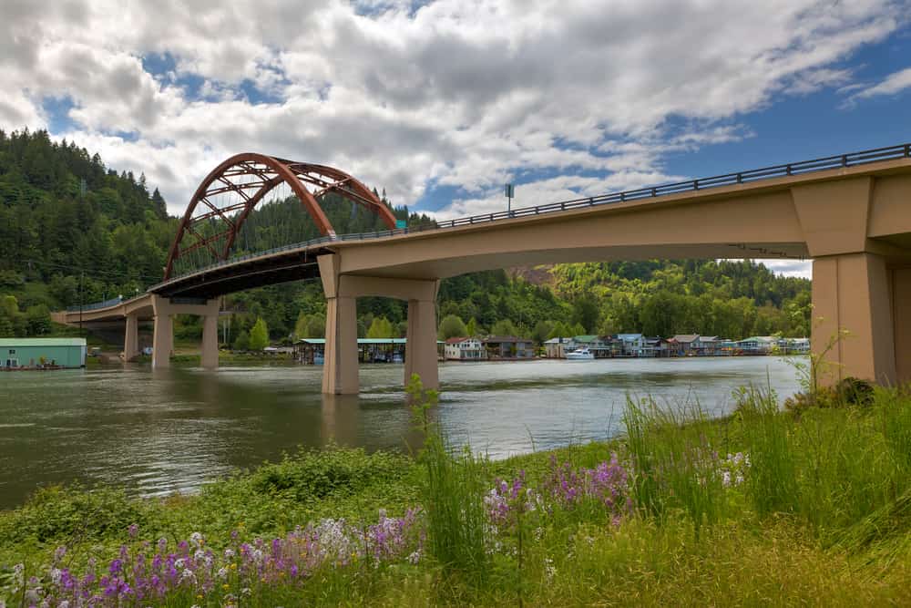 Sauvie Island Bridge with wildflowers over Floating Homes along Multnomah Channel in Portland Oregon