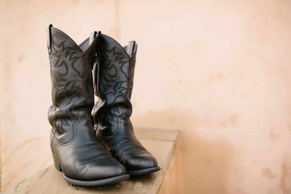 A Pair of Black Cowboy Boots on Display