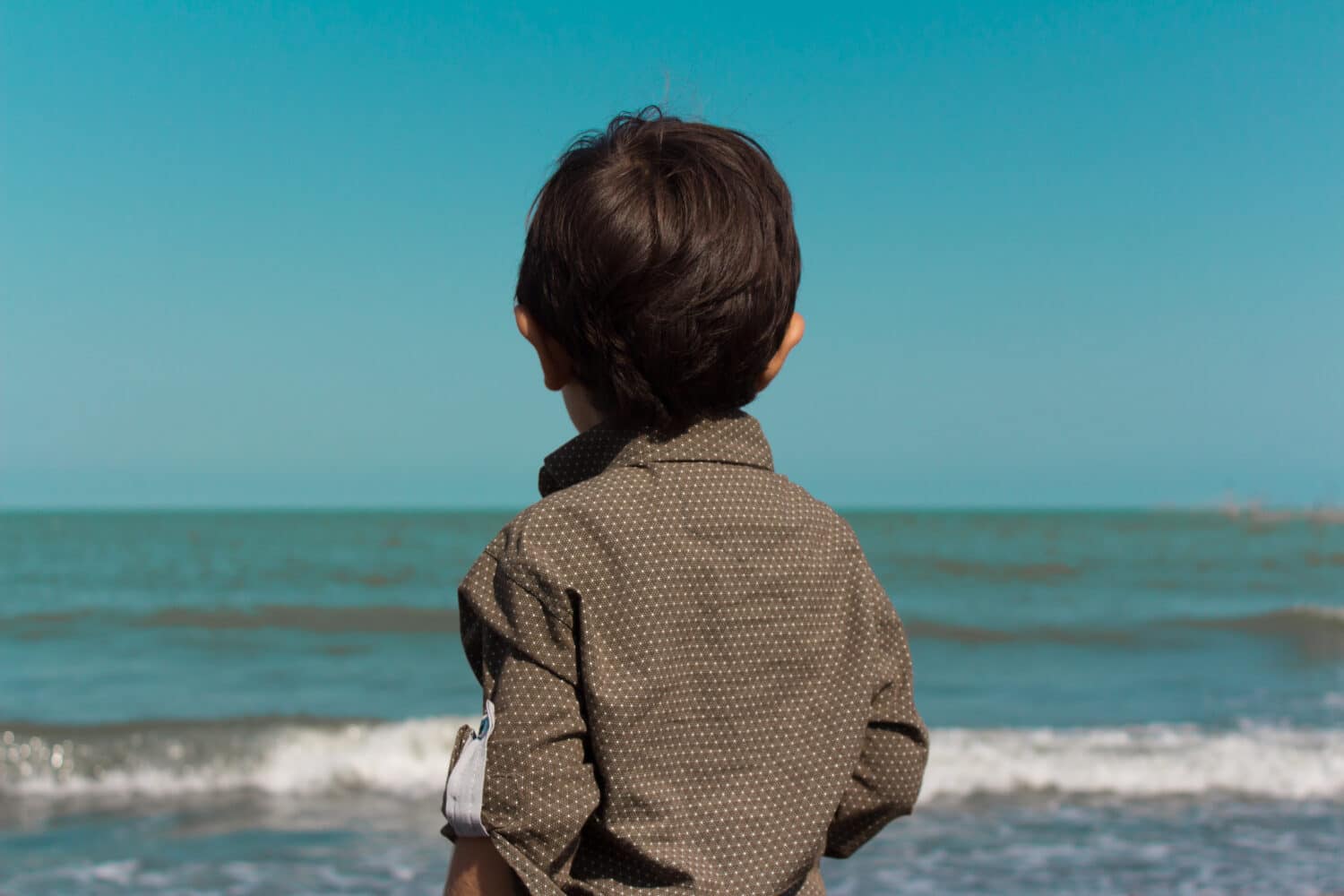 a little boy looking at the sea. Caspian Sea