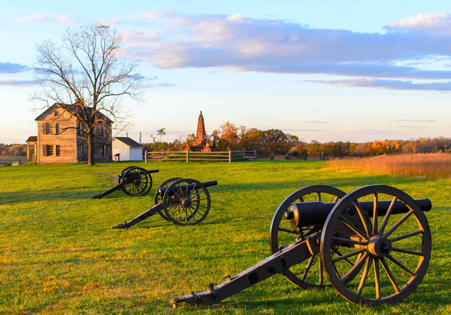 Historic Henry House and cannons at Manassas National Battlefield Park during sunset